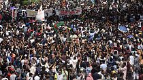 People shout slogans as they take part in a protest against Prime Minister Sheikh Hasina in Dhaka, Bangladesh, Monday, Aug. 5, 2024.