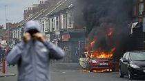 A car burns during an anti-immigration protest in Middlesbrough, England, Sunday Aug. 4, 2024. 