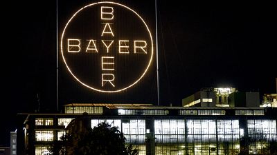 The Bayer logo shines at night at the main chemical plant of German Bayer AG on Thursday, Aug. 9, 2019 in Leverkusen, Germany. 