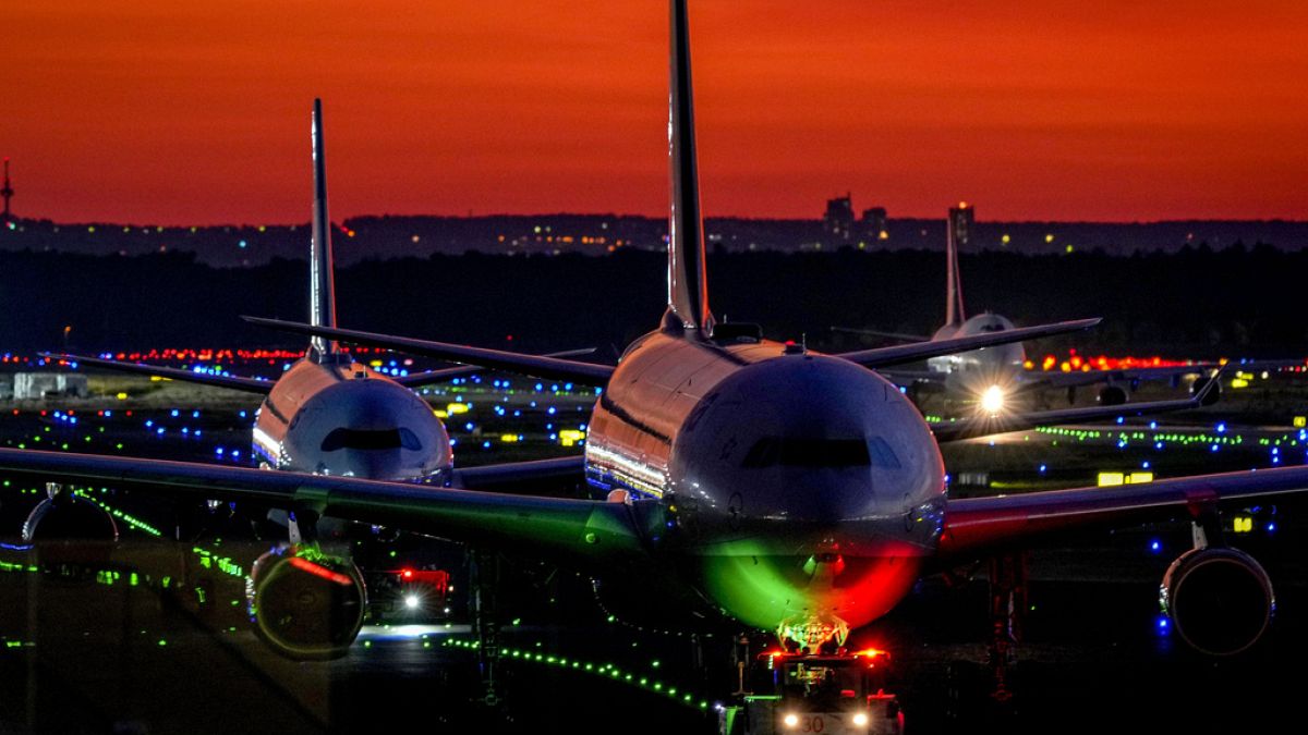 FILE - Aircrafts roll over a runway at the airport in Frankfurt, Germany, after sunset on Thursday, Sept. 23, 2021. 