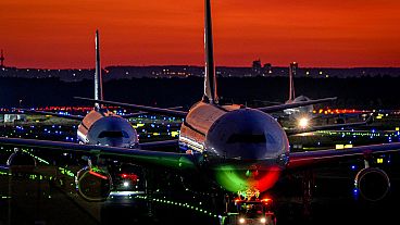 FILE - Aircrafts roll over a runway at the airport in Frankfurt, Germany, after sunset on Thursday, Sept. 23, 2021. 
