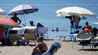 Sunbathers enjoy the beach in Ostia, near Rome.