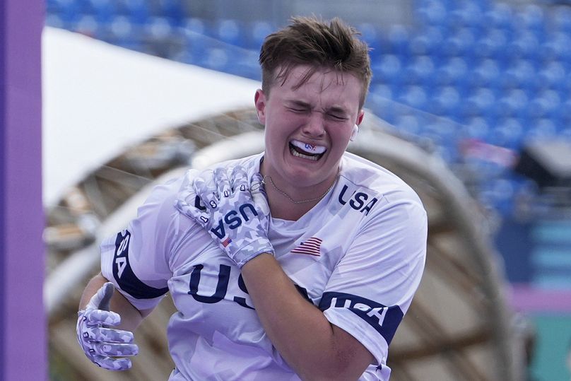 Hannah Roberts, of the United States, grimaces and runs away holding her shoulder after apparently getting injured in a collision