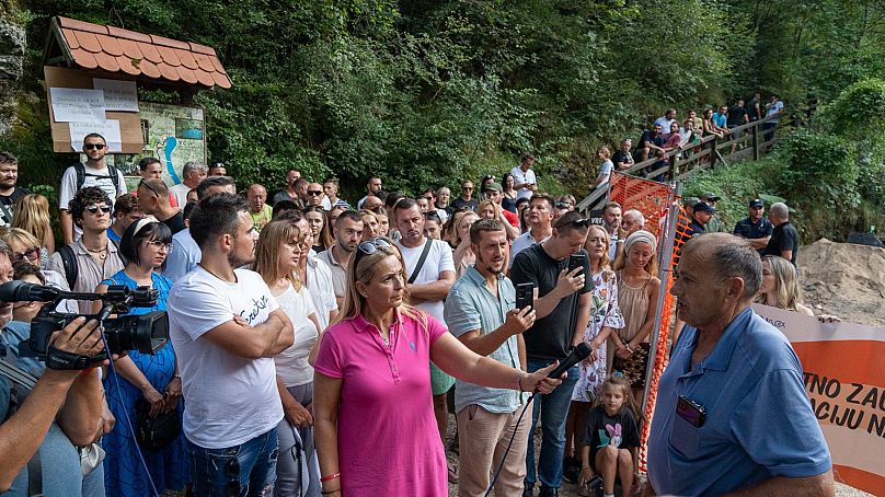 Protesters gather at the source of the Una River. 