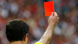 A referee handing out a red card