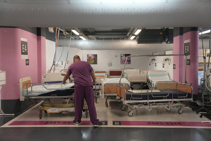 A member of the medical staff at Rambam Hospital prepares a bed in an underground parking garage in preparation for an escalation in hostilities, in Haifa, Israel.