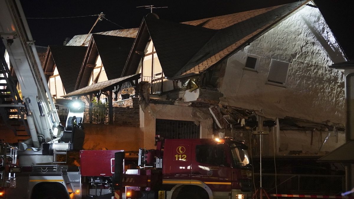 A fire department vehicle stands in front of a collapsed hotel in Kroev, Germany Wednesday, Aug. 7, 2024.