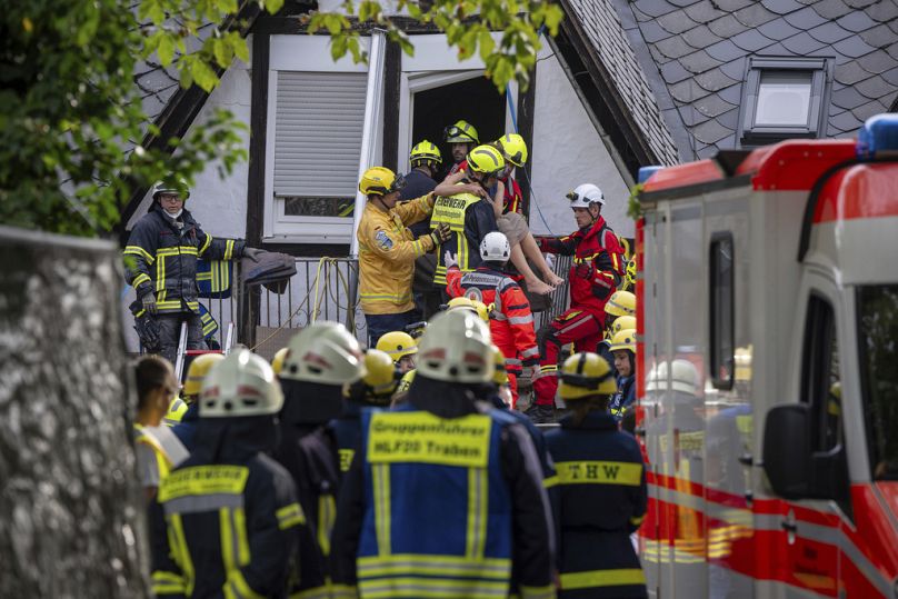 A person is rescued from the partially collapsed hotel in Kroev, Germany Wednesday, Aug. 7, 2024. 