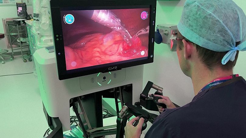 Ewan Brownlee, Consultant paediatric urologist at University Hospital Southampton using joystick controls to perform the surgery