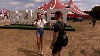 Imagen de una pareja de aficionados a la música en el espacio donde se celebra el prestigioso Festival de Sziget, en Budapest.