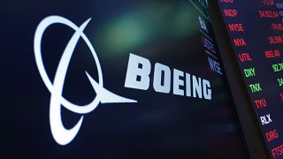 The logo for Boeing appears on a screen above a trading post on the floor of the New York Stock Exchange, July 13, 2021.