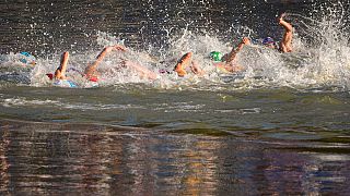 Athletes compete during the swim leg of mixed relay triathlon at the 2024 Summer Olympics, Monday, Aug. 5, 2024, in Paris, France.