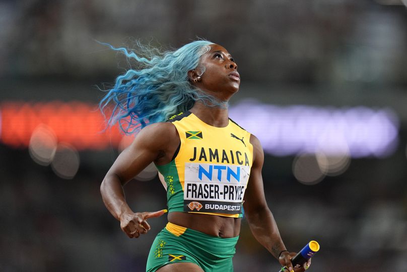 Shelly-Ann Fraser-Pryce, of Jamaica anchors her team to win a Women's 4x100-meters relay heat during the 2023 World Athletics Championships in Budapest