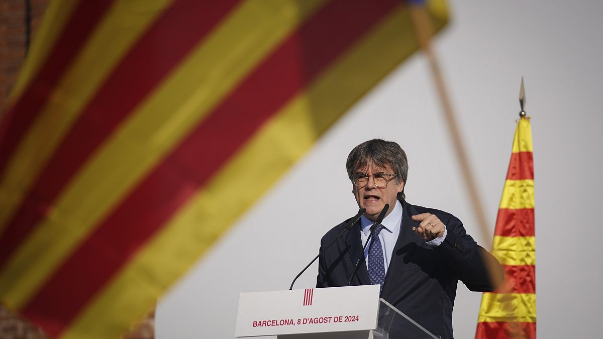 Puigdemont defies arrest warrant to lead Barcelona rally