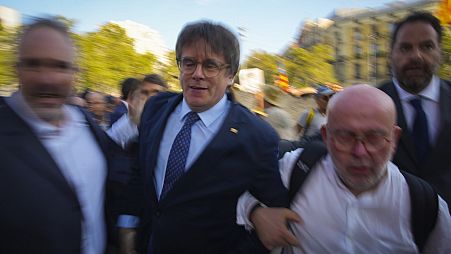 Catalan independence leader and former President Carles Puigdemont arrives to allegedly attend the investiture debate in Barcelona, Spain, Thursday, Aug. 8,