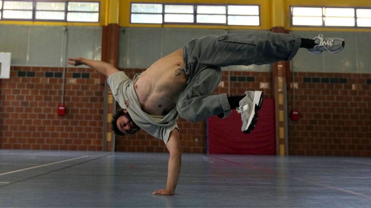 Alexandre Sazy breakdances in a gymnasium at the 2024 Summer Olympics, Tuesday, July 30, 2024, in Paris, France.