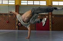 Alexandre Sazy breakdances in a gymnasium at the 2024 Summer Olympics, Tuesday, July 30, 2024, in Paris, France.