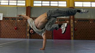 Alexandre Sazy breakdances in a gymnasium at the 2024 Summer Olympics, Tuesday, July 30, 2024, in Paris, France.