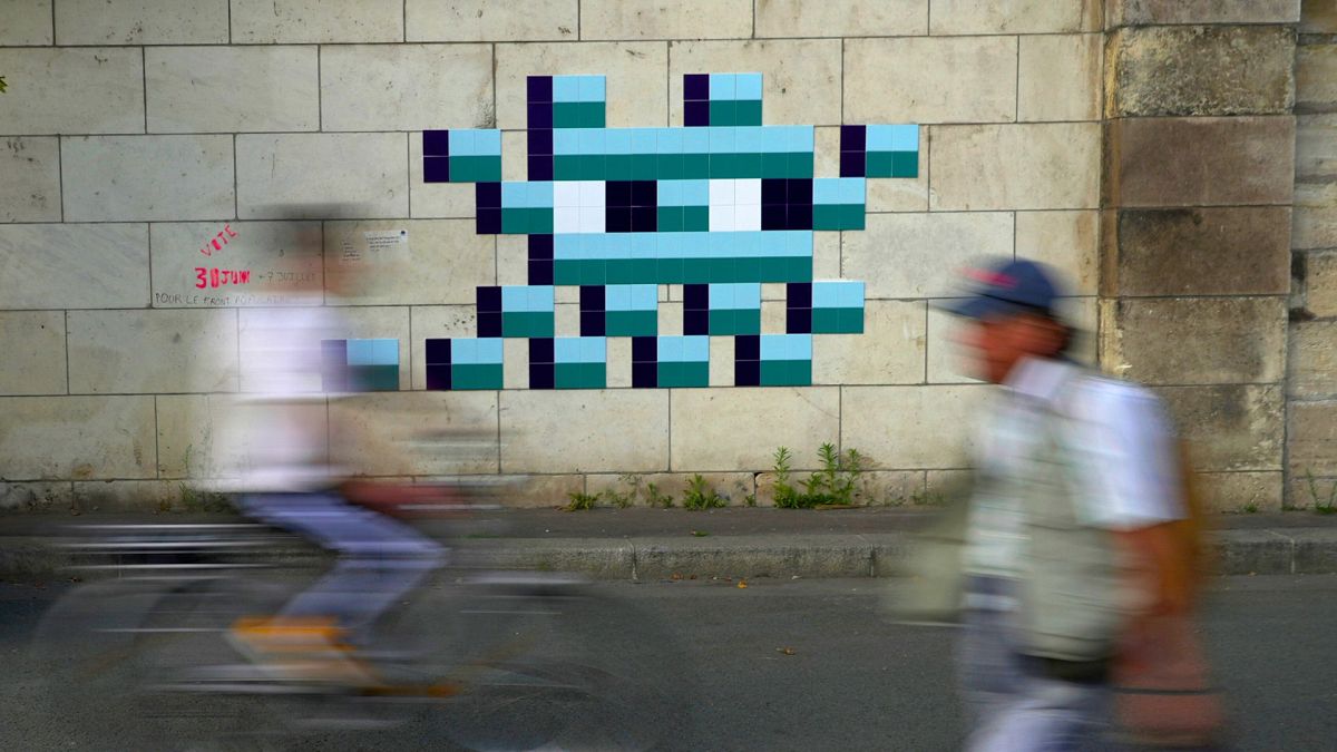 Mystery Paris street artist 'Invader' glues up new work to celebrate Olympics and delight fans