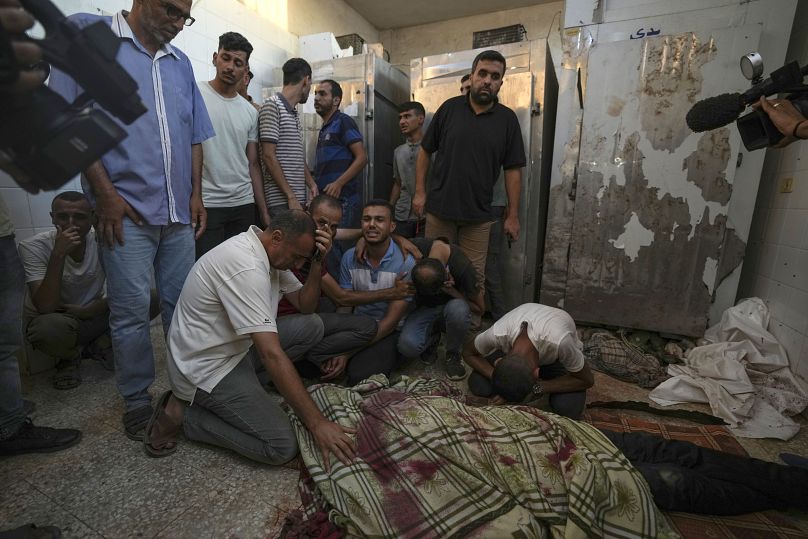 Palestinians mourn the victims of an Israeli airstrike in Deir al Balah, Gaza Strip, 