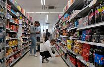 Shoppers buy food in a supermarket in London, on Aug. 17, 2022.