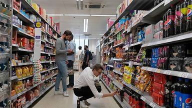 Shoppers buy food in a supermarket in London, on Aug. 17, 2022.