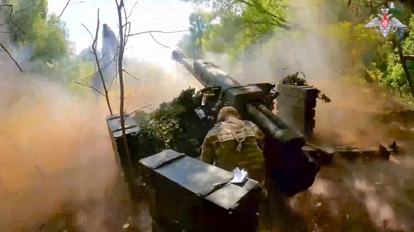 A Russian soldier fires from D-30 howitzer towards Ukrainian positions in an undisclosed location in Ukraine, 7 August 2024