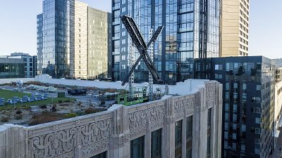 An "X" sign rests atop the company headquarters in downtown San Francisco, on July 28, 2023