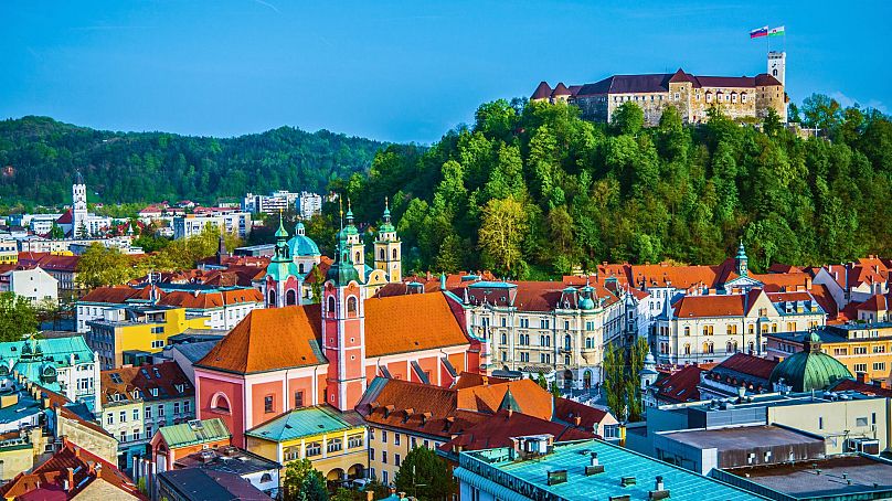 Ljubljana is lined with pastel-coloured buildings.