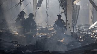 Emergency workers search for victims after Russian missile hit a supermarket in Kostiantynivka, Donetsk region, Ukraine, Friday, Aug. 9, 2024.