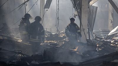 Emergency workers search for victims after Russian missile hit a supermarket in Kostiantynivka, Donetsk region, Ukraine, Friday, Aug. 9, 2024.