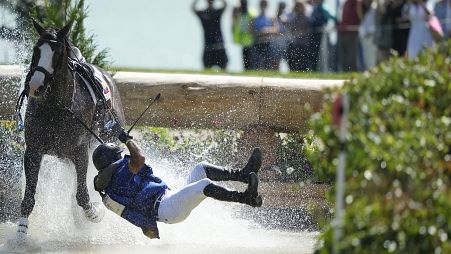 Ecuador's Ronald Zabala G., fall off their horse during the Equestrian Cross Country competition at Chateau de Versailles on July 28, 2024
