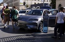 Visitors watch a BYD Seal U car at the IAA motor show in Munich, Germany, Friday, Sept. 8, 2023.