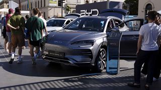 Visitors watch a BYD Seal U car at the IAA motor show in Munich, Germany, Friday, Sept. 8, 2023.