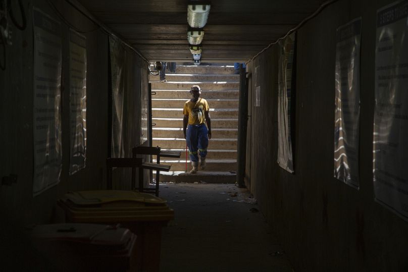 A miner walks at the entrance of a goldmine shaft in Springs, October 2023