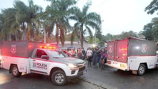 Police vehicles used to carry bodies arrive at the gated community where a plane crashed in Vinhedo, Sao Paulo state, 9 August 2024