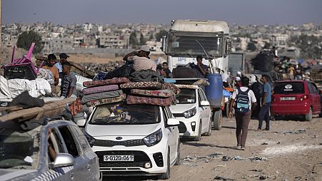 Palestinians flee the Khan Younis area of the Gaza Strip, following Israeli military evacuation orders, saying its forces will soon operate there, Thursday, Aug. 8, 2024.