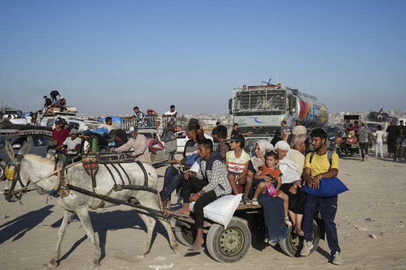 Palestinians flee the Khan Younis area of the Gaza Strip, following Israeli military evacuation orders, saying its forces will soon operate there, Thursday, Aug. 8, 2024.