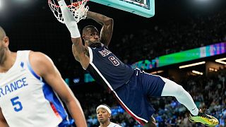 United States' LeBron James (6) dunks over Nicolas Batum (5), of France during a men's gold medal basketball game at Bercy Arena