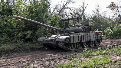 In this photo taken from video released by the Russian Defense Ministry on Saturday, Aug. 10, 2024, a Russian Army tank takes a position at an area of Kursk region of Russia