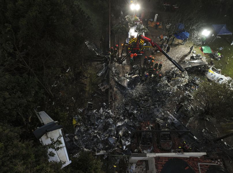 Vigili del fuoco e soccorritori lavorano tra i detriti nel luogo in cui l'aereo è precipitato a Vinhedo, San Paolo, Brasile, 10 agosto 2024