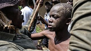 A mass circumcision is marketed to tourists in a remote area of Uganda