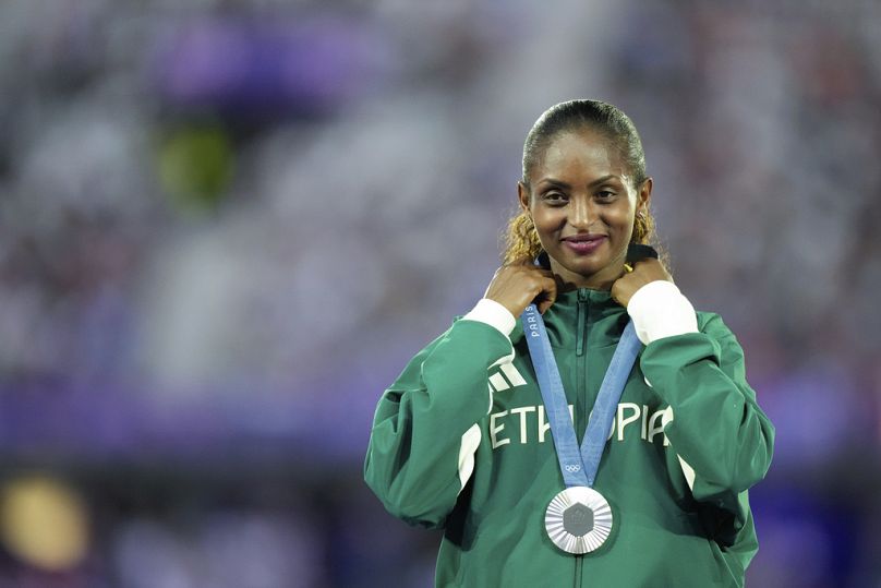 Women's marathon silver medalist Tigst Assefa of Ethiopia stands on the podium during the 2024 Summer Olympics closing ceremony at the Stade de France