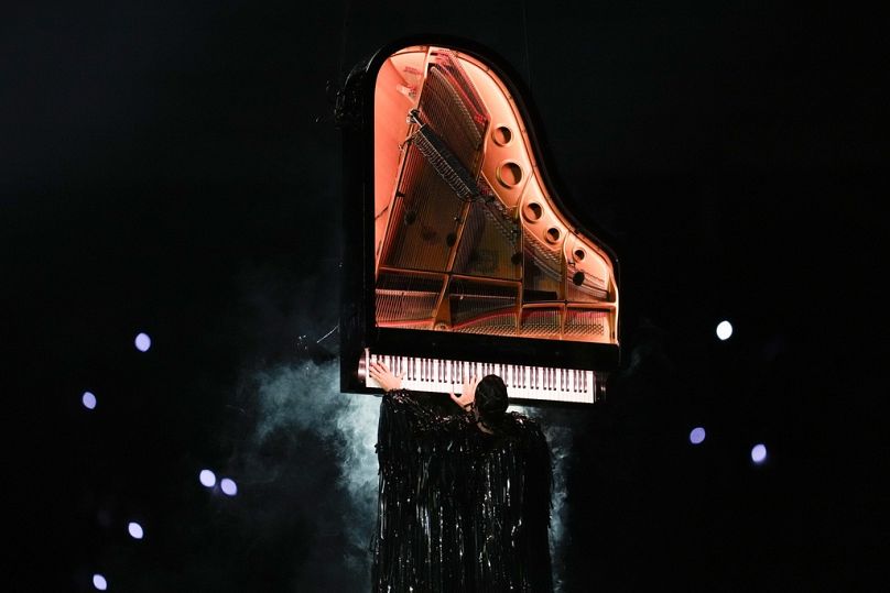 Artist Alain Roche plays on a suspended piano during the 2024 Summer Olympics closing ceremony at the Stade de France, Sunday, Aug. 11, 2024, in Saint-Denis, France