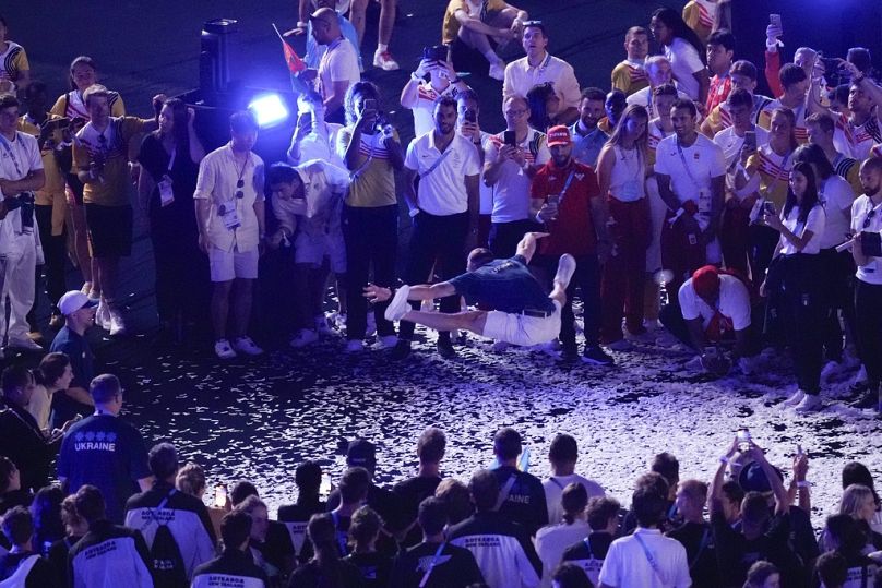 Athletes dance during the closing ceremony of the Paris 2024 Olympics