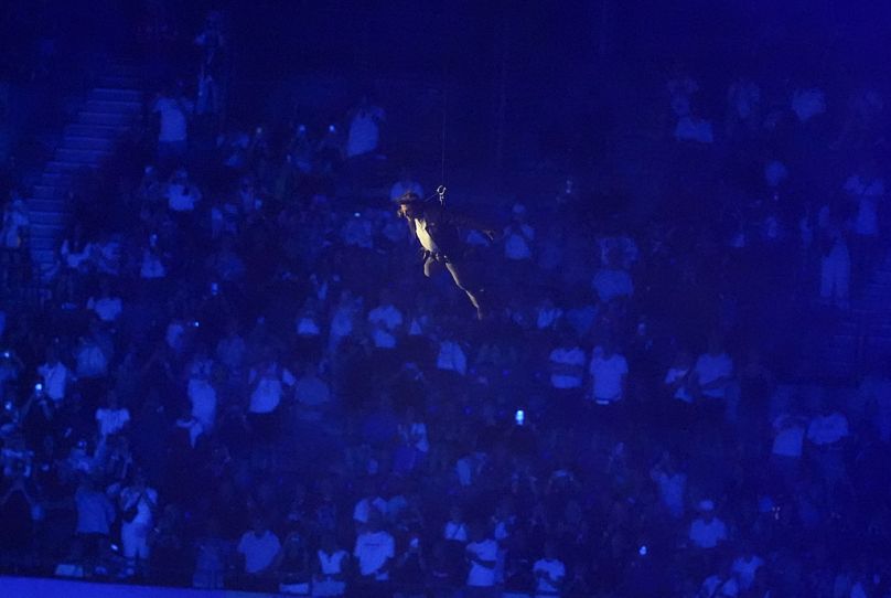 Tom Cruise is lowered into the stadium during the 2024 Summer Olympics closing ceremony at the Stade de France, Sunday, Aug. 11, 2024, in Saint-Denis, France