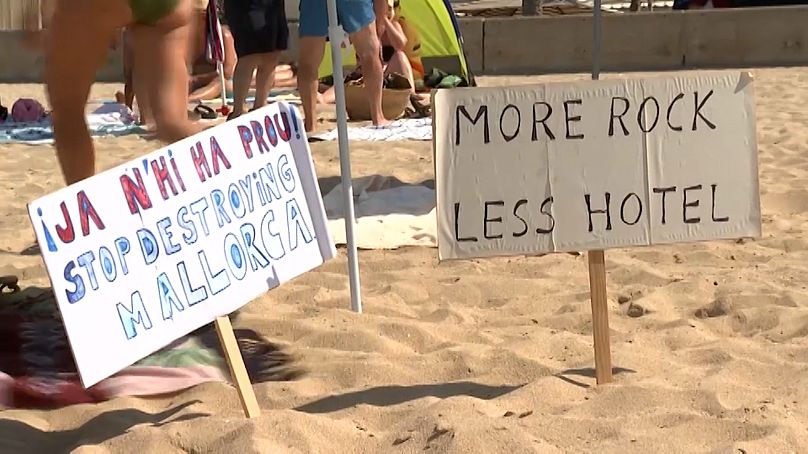 Protest signs on the Baleario 6 beach.