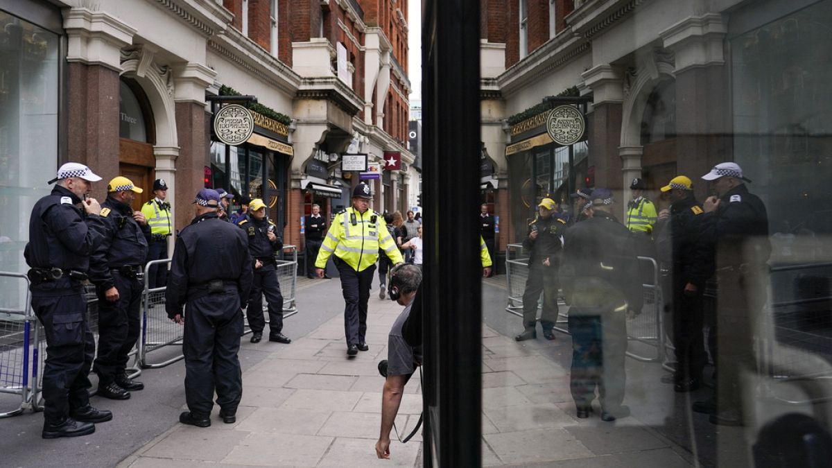 Police officers patrol outside the London offices of the political party Reform UK, ahead of an anti-far right protest, in London, Saturday, Aug. 10, 2024.