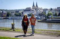 Freed Russian artist Sasha Skochilenko and her partner, Sonya Subbotina, walk at the banks of the Mosel River in Koblenz.