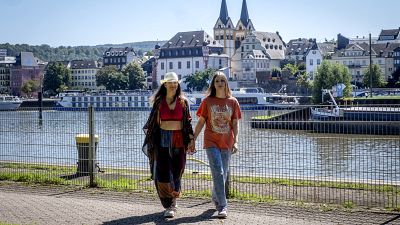 Freed Russian artist Sasha Skochilenko and her partner, Sonya Subbotina, walk at the banks of the Mosel River in Koblenz.